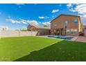 A spacious backyard featuring a pool and well-maintained artificial grass at 32 W Desert Vista Trl, San Tan Valley, AZ 85143