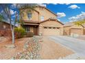 Two-story home featuring a well-manicured yard, covered porch, and a two car garage at 32 W Desert Vista Trl, San Tan Valley, AZ 85143