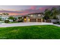 Beautiful two-story home with a well-manicured lawn and mature trees at 3603 E Indigo Bay Ct, Gilbert, AZ 85234