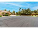 Scenic view of a two-story home surrounded by lush landscaping and mature trees at 3603 E Indigo Bay Ct, Gilbert, AZ 85234