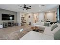 Comfortable living room with neutral walls, a large sectional sofa, and stylish furnishings at 4143 E Appaloosa Rd, Gilbert, AZ 85296