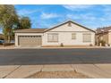 Charming single-story home featuring a two-car garage and neutral-toned stucco exterior at 4226 E Spawn Ln, Gilbert, AZ 85296