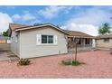 Side view of a single-story home with neutral siding and desert landscaping, showcasing its neat presentation at 4626 W Mitchell Dr, Phoenix, AZ 85031