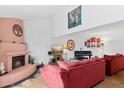 Bright living room with a cozy fireplace, tall ceilings, comfortable seating, and natural light creating a warm atmosphere at 5326 N 3Rd Ave, Phoenix, AZ 85013