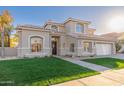 Beautiful two-story home with a well-manicured lawn, three car garage, and elegant design at 5433 E Nisbet Rd, Scottsdale, AZ 85254