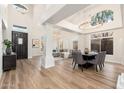 Elegant living room with wood floors, a large window, columns, and modern chandeliers at 5433 E Nisbet Rd, Scottsdale, AZ 85254