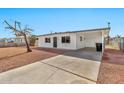 Charming single-story home with a carport, well-maintained exterior, and desert landscaping at 7113 E Bell Cir, Mesa, AZ 85208