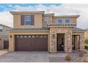 Two-story home featuring a charming blend of stucco and stone facade, offering a warm and inviting curb appeal at 7337 S Debra Dr, Gilbert, AZ 85298