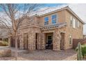 Charming exterior featuring stone accents, covered porch, and a well-maintained desert landscape at 7337 S Debra Dr, Gilbert, AZ 85298