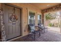 Inviting front porch with stone accents, brick paving, and cozy seating, perfect for relaxing outdoors at 7337 S Debra Dr, Gilbert, AZ 85298