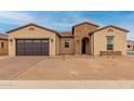 Charming single-story home with a brick-accented entrance and a convenient two-car garage at 742 E Watermelon Ln, Queen Creek, AZ 85140