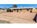 Cozy single-story brick home with a low-maintenance rock front yard, covered carport, and inviting curb appeal at 8612 N 31St Ln, Phoenix, AZ 85051