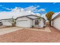 Front exterior view showing a 2-car garage, desert landscaping and a well-maintained home at 8826 W Amelia Ave, Phoenix, AZ 85037