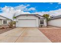 Charming single-story home with a two-car garage, manicured landscaping, and a well-maintained front yard at 8826 W Amelia Ave, Phoenix, AZ 85037