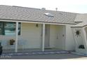 Inviting front entrance of the home with covered porch and a lovely seating area at 10612 N 102Nd Dr, Sun City, AZ 85351