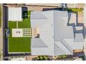 Aerial view of a modern home with an artificial grass backyard and a pergola at 10635 E Tesla Ave, Mesa, AZ 85212