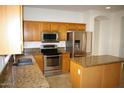 Kitchen featuring stainless steel appliances and wooden cabinetry at 1083 E Jade Dr, Chandler, AZ 85286