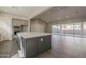 Spacious kitchen featuring large island, sleek countertops, stainless steel appliances, and open floor plan at 10972 N Hershey St, Surprise, AZ 85388