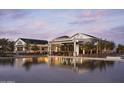 Luxury clubhouse exterior reflected in a serene pool at twilight, evoking a resort atmosphere at 11300 N Casa Dega Dr # 1012, Surprise, AZ 85388