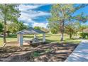 Community park featuring a covered picnic area with seating nestled in lush green space with walking path at 1133 N Florence Dr, Chandler, AZ 85226