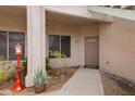 Inviting condo entrance with a cozy porch, desert landscaping, and neutral color scheme at 11616 N Saguaro Blvd # 2, Fountain Hills, AZ 85268