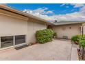 Secluded outdoor patio with a roller shade on the window and ample space for seating at 12810 W Ashwood Dr, Sun City West, AZ 85375