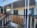 Inviting covered porch with sturdy railings and peaceful outdoor sitting area at 13229 N 19Th Pl, Phoenix, AZ 85022