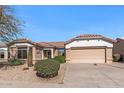 Inviting single-story home with desert landscaping, complemented by a tile roof and a convenient two-car garage at 14314 W Pecos Ln, Sun City West, AZ 85375