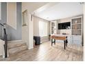 Living room area with wood floors and a built-in entertainment center at 15658 W Cortez St, Surprise, AZ 85379