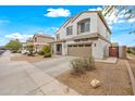 Charming two-story home with a well-manicured front yard, a two-car garage, and neutral paint at 17771 W Caribbean Ln, Surprise, AZ 85388