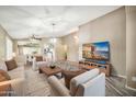 Inviting living room with cozy furniture, an open layout, stylish decor, and a TV for entertainment at 18097 W Santa Alberta Ln, Goodyear, AZ 85338