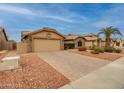 Attractive single-story home with a two-car garage, paved driveway, and desert landscaping at 18730 N 89Th Ave, Peoria, AZ 85382