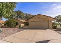 Well-maintained house boasts a large driveway, two-car garage, and low-maintenance desert landscaping at 19503 N 142Nd Dr, Sun City West, AZ 85375