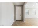 Bright entryway featuring a white front door, tile floors, and an open doorway to the next room at 21056 N 58Th St, Phoenix, AZ 85054