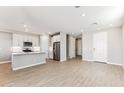 Bright open-concept living space featuring wood-look flooring, recessed lighting, and a view of the entryway at 21074 N 58Th St, Phoenix, AZ 85054