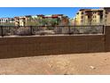 Well-maintained brick retaining wall with black metal fencing in front of modern apartment complex at 21126 N 58Th St, Phoenix, AZ 85054