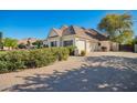 Paver driveway leading to a home with an attached garage, surrounded by mature trees and landscaping at 2467 E Page Ave, Gilbert, AZ 85234