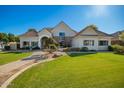 Inviting single-story home with a lush green lawn, mature landscaping, and a brick walkway to the entrance at 2467 E Page Ave, Gilbert, AZ 85234