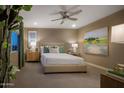 Bedroom with a neutral palette, ceiling fan, window, and an abstract painting enhancing the decor at 2468 W Rowel Rd, Phoenix, AZ 85085