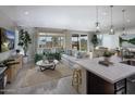 Bright open-concept living room with comfortable seating and natural light from large windows and sliding doors at 2468 W Rowel Rd, Phoenix, AZ 85085