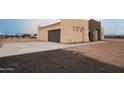 Attached garage showcasing the home's exterior and driveway at 29810 W Bellview St, Buckeye, AZ 85396