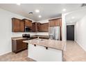 Kitchen featuring stainless steel appliances, an island with sink and ample wooden cabinets at 29997 N 70Th Dr, Peoria, AZ 85383