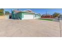 Side view of a charming home with a two-car garage and rock landscaping at 3102 W Desert Cove Ave, Phoenix, AZ 85029