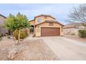 Two-story home with a desert landscape, two car garage, and a charming arched entry at 35030 N Barzona Trl, San Tan Valley, AZ 85143