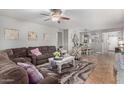 Inviting living room with a large sectional sofa, ceiling fan, and decor at 41260 N Salix Dr, San Tan Valley, AZ 85140