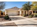 Inviting single-story home showcasing desert landscaping, a tile roof, and a two-car garage at 4189 E Sandy Way, Gilbert, AZ 85297