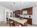 Spacious kitchen featuring a large island, granite countertops, and stylish pendant lighting at 474 W Smoke Tree Rd, Gilbert, AZ 85233