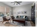 Inviting living room with neutral walls, a dark wood coffee table, and comfortable seating with a ceiling fan at 5513 S Coyote Cyn, Mesa, AZ 85212