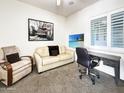 Bright office featuring neutral carpet, a built-in desk, plush seating, and shuttered windows at 6039 E Sienna Bouquet Pl, Cave Creek, AZ 85331