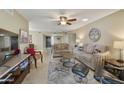 Cozy living room featuring tile flooring, comfortable sofas, coffee tables, and an abundance of natural light at 617 S Palo Verde Way, Mesa, AZ 85208